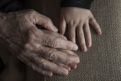 Close-up of parent holding child hand