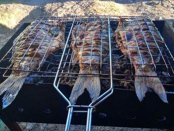 High angle view of fish on barbecue grill