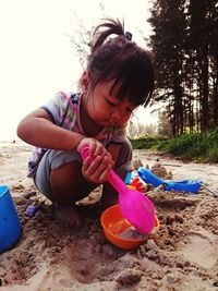 Girl playing on sand at beach