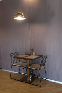 Empty chairs and table against wall at home