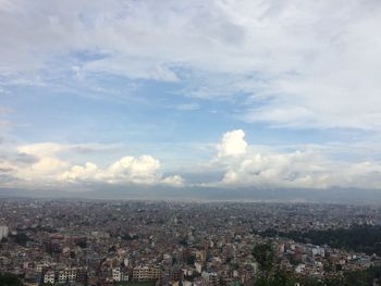 Aerial view of cityscape against sky