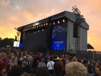 Crowd at music concert against sky