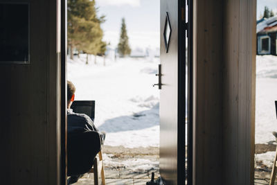 Businessman working seen through doorway