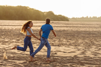 Full length of boy running at beach