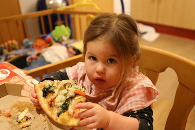 Portrait of girl holding food