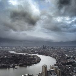 Cityscape against cloudy sky