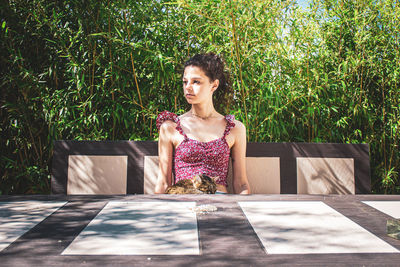 Portrait of woman against plants