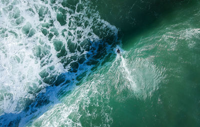 High angle view of man with surfboard on sea