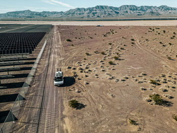 Off grid self contained campervan van life recreational vehicle parked next to a massive solar farm