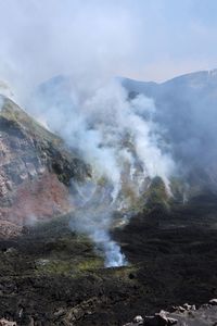 Smoke emitting from volcanic mountain