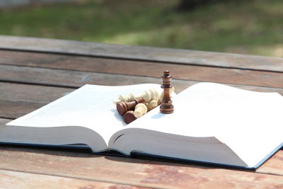 Close-up of chess piece on book at table