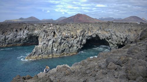 Scenic view of rocks and sea against sky