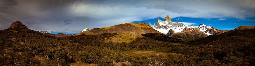 Scenic view of mountains against cloudy sky