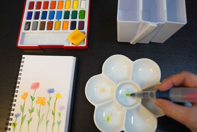 High angle view of woman holding paintbrush