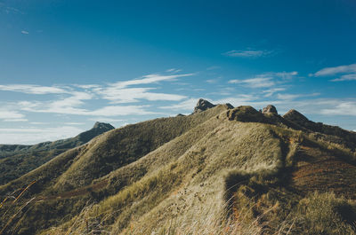Scenic view of landscape against cloudy sky