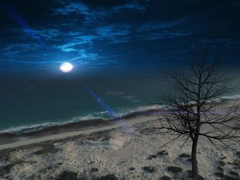 Scenic view of snow covered land against sky at night