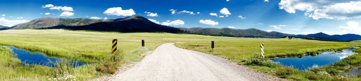 Empty road leading towards mountains