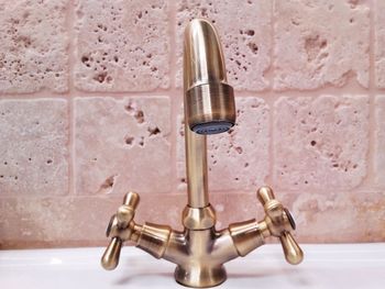 Close-up of faucet in bathroom