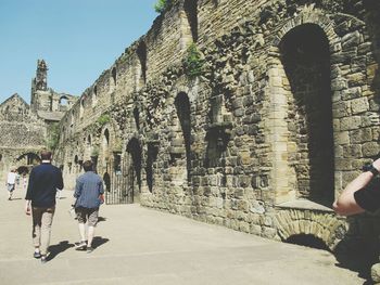 People at kirkstall abbey on sunny day