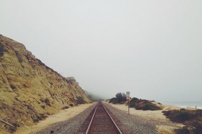 Railroad tracks against clear sky