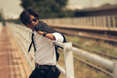 Man standing by fence