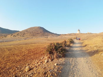 Dirt road on landscape against clear sky, in cabo de gata, almería, andalucia