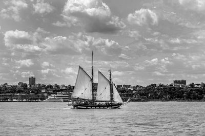 Ship on lake against cloudy sky