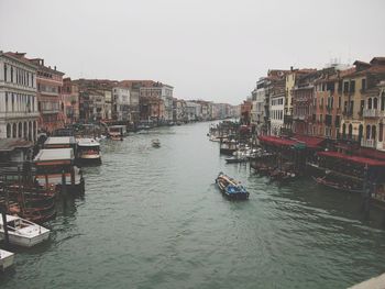 Boats in river with buildings in background