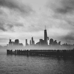 Cityscape against cloudy sky