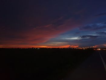 Silhouette landscape against dramatic sky during sunset