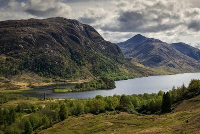 Scenic view of mountains against cloudy sky