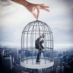 Man with umbrella standing by cityscape against sky