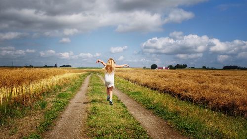 Full length of people walking on grassy field