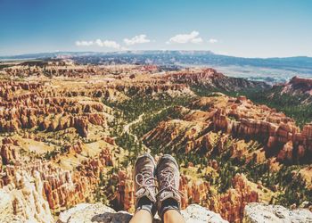 Low section of man legs by rocky mountains at bryce canyon national park