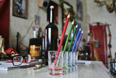 Close-up of multi colored bottles on table