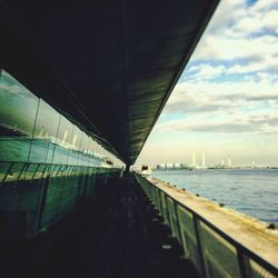 View of bridge over river against cloudy sky