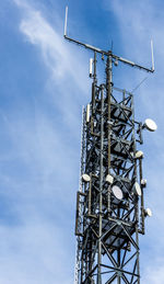 Low angle view of communications tower against sky