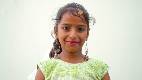Indian beautiful little girl with garba sticks or dandiya on indian festival navratri.
