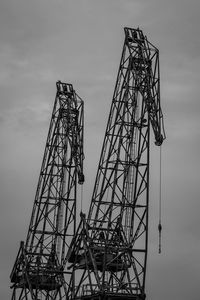 Low angle view of crane against sky