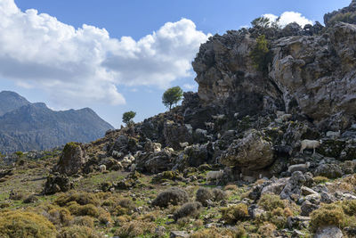 Rock formations on landscape against sky