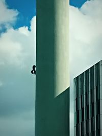 Low angle view of building against cloudy sky