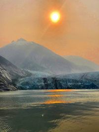 Scenic view of lake against sky during sunset