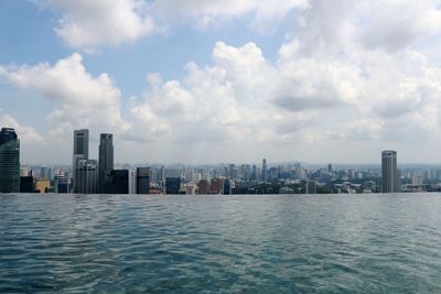 Cityscape against cloudy sky