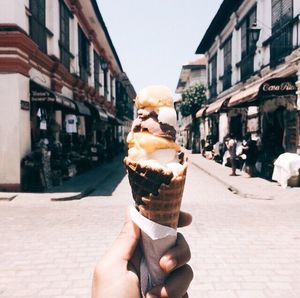 Cropped hand holding ice cream cone