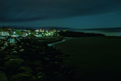 Aerial view of illuminated buildings in city at night