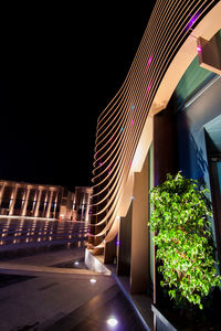 Illuminated modern building against sky at night