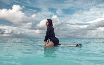 Full length of man in sea against sky