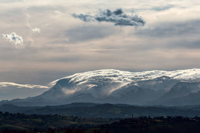 Scenic view of snowcapped mountains against sky