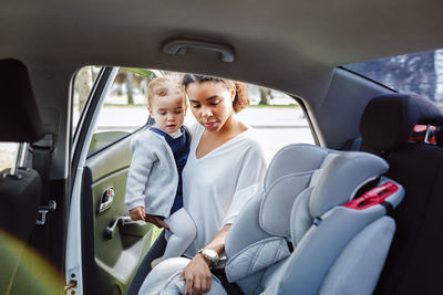 Rear view of couple sitting in car