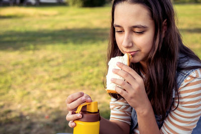 Young woman drinking water from bottle